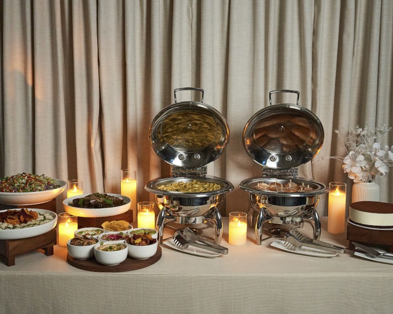 Chafing dishes on a candlelit buffet