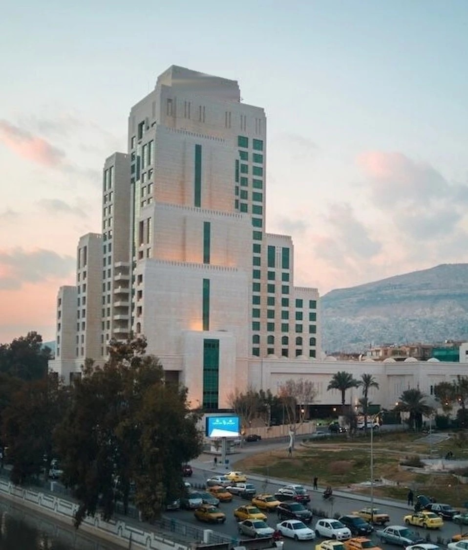 A hotel tower in central Damascus at dusk